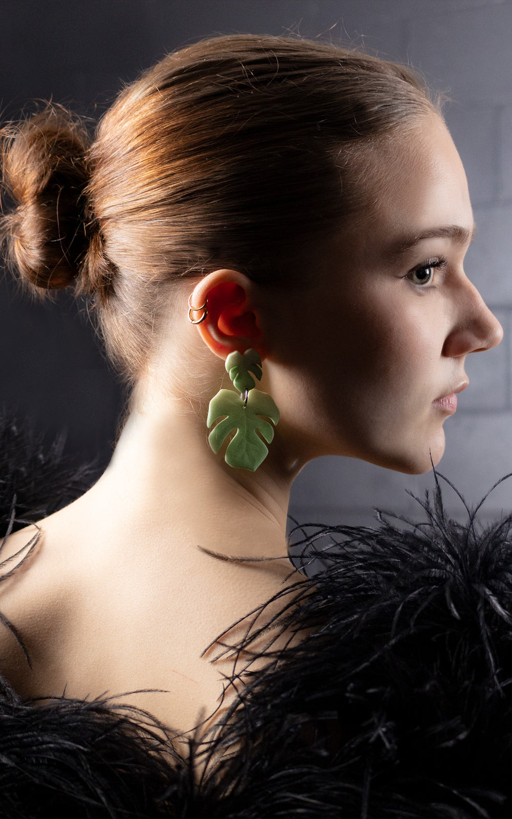 La boucle d’oreille MAUI – version double feuille de Monstera – s’impose ici avec élégance. Portée par une jeune femme au dressing raffiné, ce bijou évoque une jungle urbaine assumée. L’effet superposé des deux feuilles crée un mouvement graphique et organique, parfait pour celles qui marient nature et sophistication.
